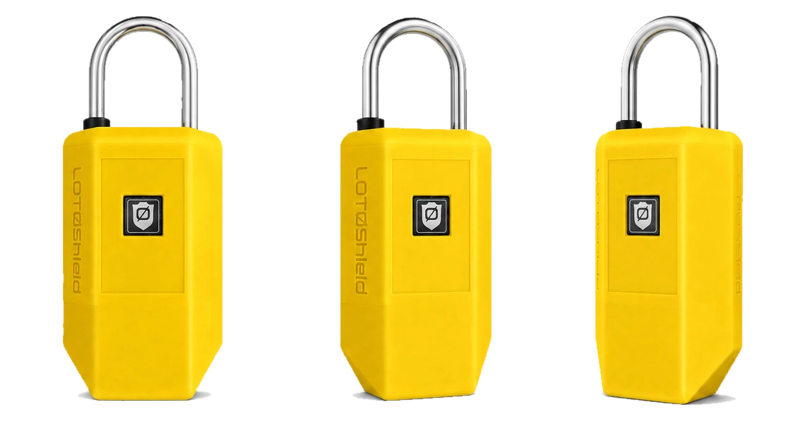 Three AT5 Intelligent Locks shown from the front and both sides: a yellow safety padlock with a steel shackle and an embossed LOTØShield wordmark